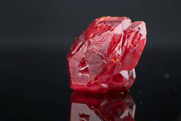 Red natural crystal mineral on a black background