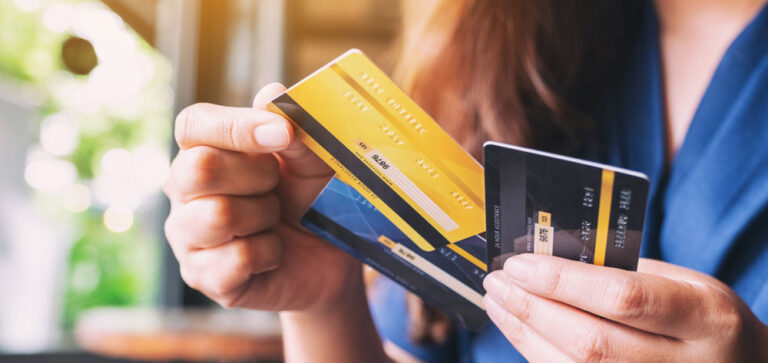 a woman holding and choosing credit card to use