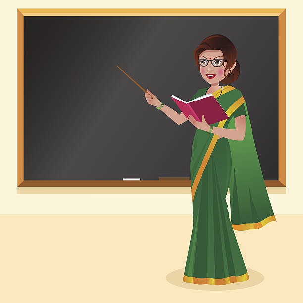 Indian teacher with reading glasses in front of blackboard with book and stick